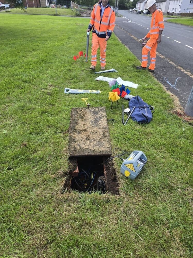 Locating a communications cable from an access box with a signal clamp