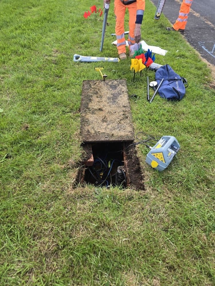 Tracing a clamped communications cable away from the access chamber
